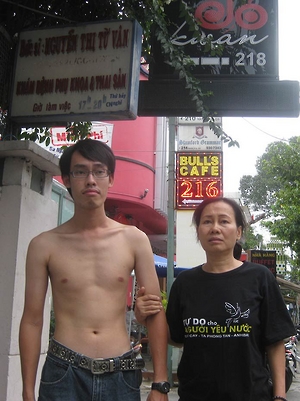 Police detained Nguyen Tri Dung and his mother to prevent them from attending the trial of three prominent bloggers, including his father Nguyen Van Hai on September 24, 2012. After the court sentenced the bloggers, police stripped Dung's t-shirt which featured the slogan: Freedom for Patriots. © 2012 VRNs