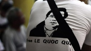A man wearing a T-shirt displaying a portrait of democracy activist Le Quoc Quan is pictured during a mass in support of Quan at a catholic church in Vietnam on July 7, 2013 (AFP/FILE)