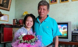 Do Thi Minh Hanh poses with her father after her release from prison, June 27, 2014. Photo courtesy of Do Thi Minh Hanh
