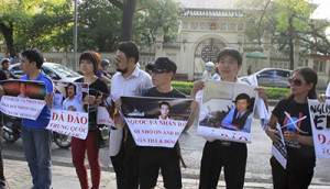 Anti-China protesters hold placards as they gather in front of the Chinese embassy in Hanoi