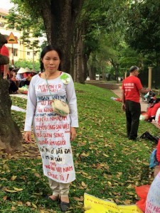 Mrs. Hai with special clothes- banner demanding land right