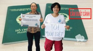 Ta Minh Tu (left) and Tran Thi Nga with banners to protest passport grant refusal of Vietnam's police