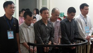 Defendant Nguyen Duc Toan (second from right) and other attackers at a trial on Nov. 16