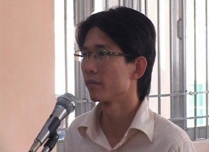 Vietnam News Agency/AFP/Getty Images Blogger Dinh Nhat Uy, 30, stands for trial at a local People's Court in the southern city of Long An on Oct. 29, 2013.