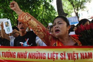 Activist Bui Thi Minh Hang (R) shouts anti-China slogans during a protest in downtown Hanoi, July 24, 2011.