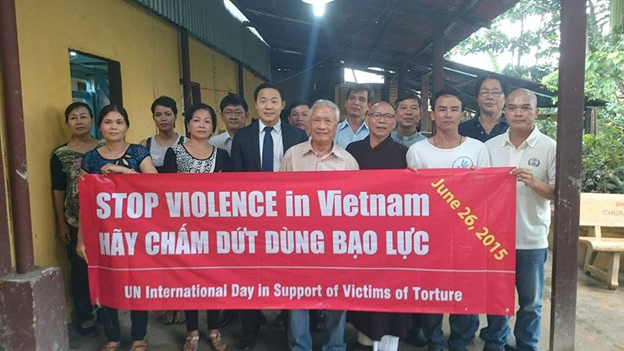 Photo: Vietnamese activists with Mr. Garrett Harkins (the US Consulate) marks the International Day in Support of Victims of Torture at Lien Tri pagoda, Saigon