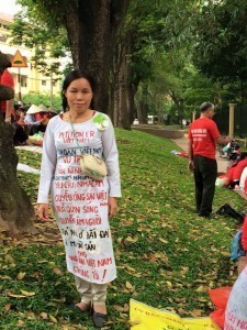 Widow Vu Thi Hai with special clothes to protest land seizure in Hanoi street