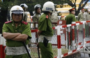 Police officers in front of a court building in political trialin HCM City