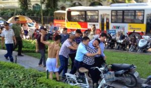 Security forces detain a peaceful protestor in Hanoi in May 2016